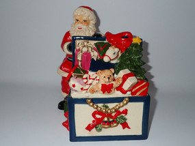 Vintage Fitz & Floyd Toyland Santa hand-painted ceramic Christmas cookie jar with Santa, teddy bear, toys and Christmas tree.