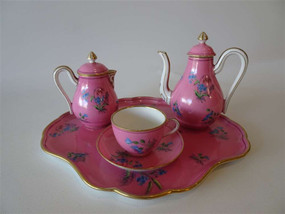 Mid 19th century child’s tea set with pink floral decoration including tray teapot creamer and cup