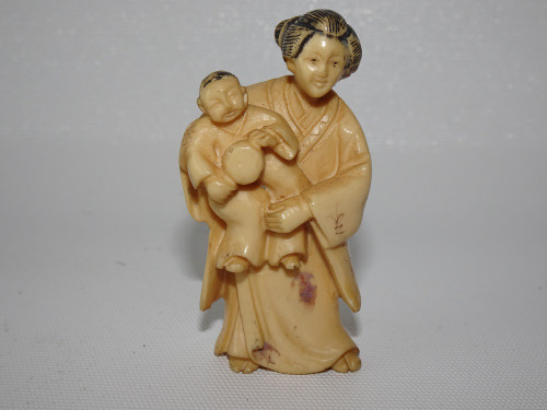 Japanese ivory netsuke woman and child, signed.