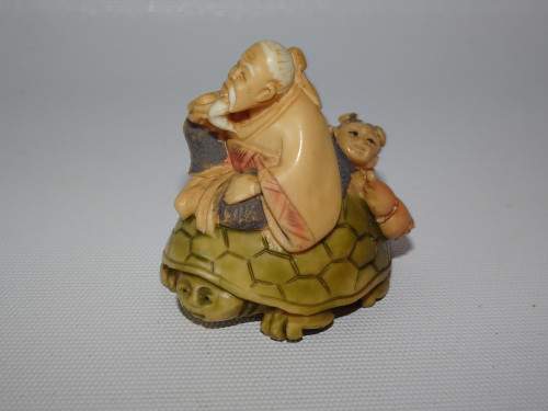 Japanese Nut Ivory Netsuke of Man and Boy Riding a Turtle