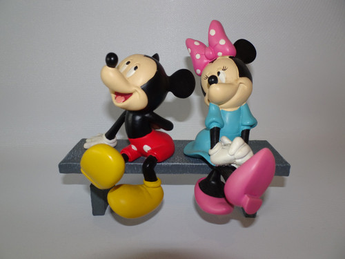 Disney Mickey and Minnie Mouse in love in love sitting on a bench, made from polyresin material circa 1990s