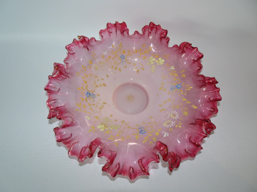 A lovley 19th century cranberry and opalescnet enameled bride's bowl with ruffled crested rim.