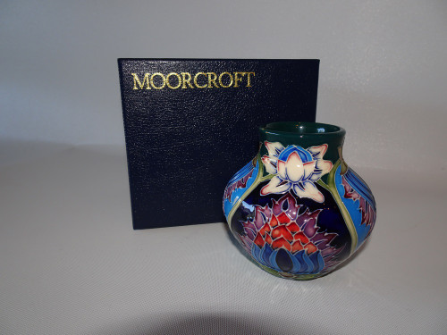 Experience the beauty of the Moorcroft Vase Saadian Design by Shirley Hayes. This exquisite piece, with its vibrant colors, will add an elegant touch to your space.