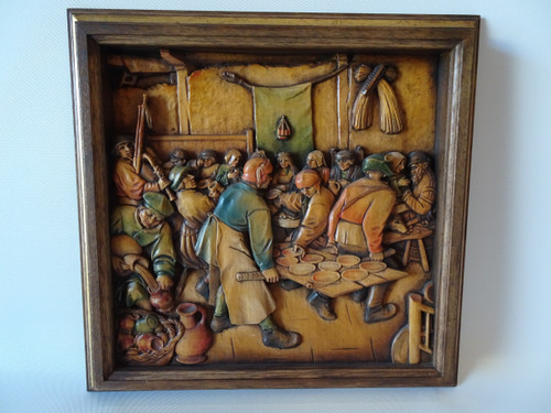 Rare original Arni woodcarving titled The Peasant Wedding Feast intricately carved with muted colour tones in original frame.