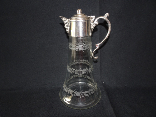 Antique silver plated claret jug with bacchus head spout and etched glass detail.