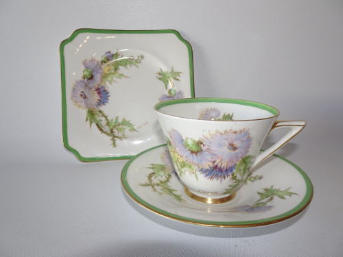 Royal Doulton Glamis Thistle trio signed by P. Curnock with thistle design – teacup, saucer, and square plate