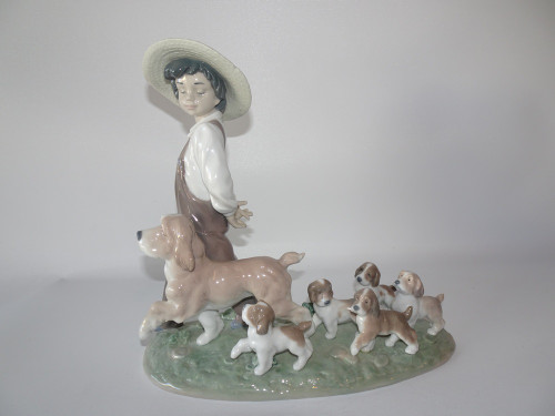 Lladro 6828 My Little Explorers porcelain figurine by Antonio Ramos, issued 2003, boy with dog and puppies, includes original box, measures 26 cm x 25 cm
