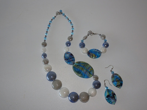 Arabella Blue – handcrafted Murano glass necklace, bracelet, and earrings set in ocean blue, silver, and pearl tones.