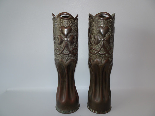 Pair of WWI trench art brass artillery shell vases with Art Nouveau scrolls and shamrock design