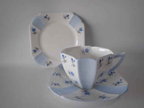Shelley Queen Anne "Charm in Blue" bone china trio with teacup, saucer and side plate, circa 1950.