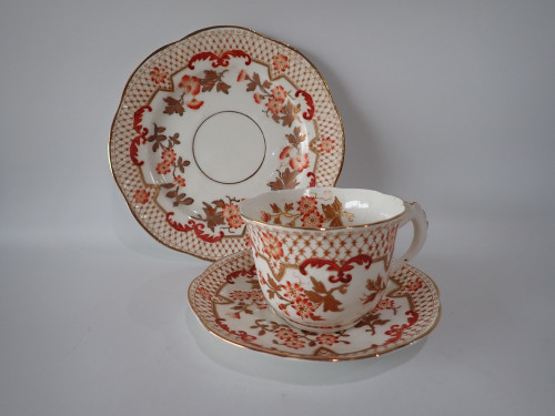 Antique Coalport attributed bone china trio with Imari-inspired red and gilt decoration, circa 1890.