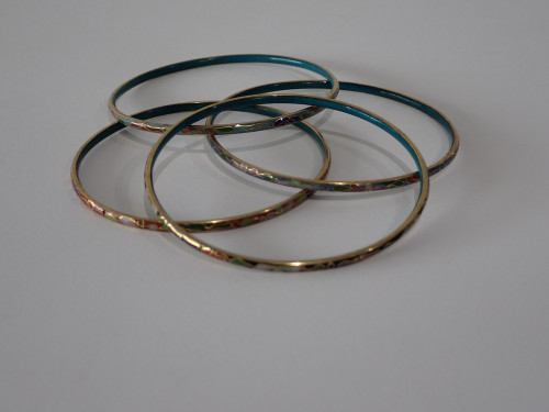 Set of four vintage Chinese cloisonné enamel bangles with multicoloured floral decoration and turquoise blue enamel interiors.
