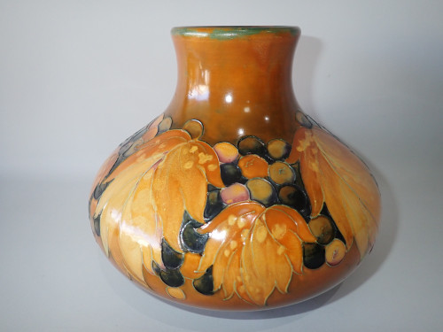 1928 William Moorcroft signed salt glaze Leaf and Berries vase in autumnal ochre, amber and brown tones.
