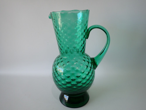 Vintage Italian emerald-green glass pitcher circa 1960s with rounded quilted and bubble-textured body, shaped pouring lip and curved handle.