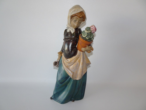 Vintage retired Lladro in gres finish girl with geranium.