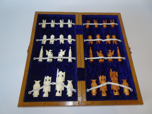 Cased Chinese ivory chess set carved in typical fashion to depict figures.  Pawns carved as eight immortals dated 1940-1950.