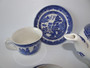 Vintage blue willow pattern tea set comprising of teapot and set of four cups and saucers.  Teapot and cups impressed with 'Made in England', saucer with 'Johnson Bros' mark.  This is the most recognised pattern in the world and still collectable today.