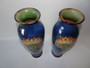 A beautiful pair of Royal Doulton Lambethware vases in mottled blue glaze and classical style acroteria to front