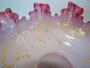 A lovley 19th century cranberry and opalescnet enameled bride's bowl with ruffled crested rim.