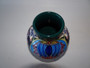 Experience the beauty of the Moorcroft Vase Saadian Design by Shirley Hayes. This exquisite piece, with its vibrant colors, will add an elegant touch to your space.