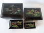 Chinese set of 4 black lacquer nesting boxes with hand painted Chinese scenic motifs on each box.