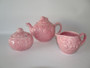 Pretty soft pink cottage  teapot, creamer and sugar embossed in fruit pattern circa 1970s.