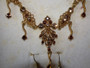 Vintage Bess gold-toned necklace and matching earrings with simulated gemstones in original presentation box.