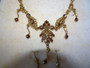 Vintage Bess gold-toned necklace and matching earrings with simulated gemstones in original presentation box.