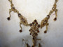 Vintage Bess gold-toned necklace and matching earrings with simulated gemstones in original presentation box.