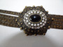 Vintage ornate bronzed bracelet with central cabochon set with faux pearls and diamonds.