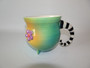 From artist Marian Mewburn comes this whymisical flower mug in vibrant colours.