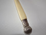 Victorian Sheffield sterling silver three-pronged bread fork with long cream-coloured handle and decorative shell finial.