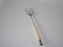 Victorian Sheffield sterling silver three-pronged bread fork with long cream-coloured handle and decorative shell finial.