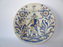 Vintage La Menora Talavera ceramic wall plate showing a hand-painted nobleman figure with floral motifs in blue and golden hues.