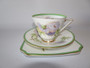 Royal Doulton Glamis Thistle trio signed by P. Curnock with thistle design – teacup, saucer, and square plate