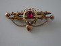 Australian Robert Rollason 9ct gold brooch with red stone, seed pearls, and heart charm circa 1900