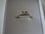 14 carat gold ring with two white diamonds set in platinum displayed inside a jewellery box.