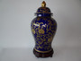 Large blue and gold decorative lidded ceramic jar on wooden stand