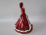 Royal Doulton Pretty Ladies Christmas Wish 2011 HN5429 figurine in red festive gown carrying a festive wreath.