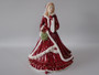 Royal Doulton Pretty Ladies Christmas Wish 2011 HN5429 figurine in red festive gown carrying a festive wreath.