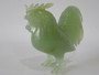 Chinese carved green hardstone rooster with finely detailed plumage and softly translucent finish, circa 1950–1970.