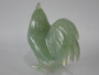 Chinese carved green hardstone rooster with finely detailed plumage and softly translucent finish, circa 1950–1970.