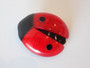 Vintage Lea Stein Paris Ladybug brooch in red swirl laminated cellulose acetate with black accents, circa 1970s–1980s.