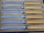 Set of six vintage stainless steel butter knives with cream ivorine-style handles in the original presentation box, dating from the 1930s–1940s.