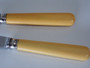 Set of six vintage stainless steel butter knives with cream ivorine-style handles in the original presentation box, dating from the 1930s–1940s.