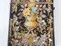 Victorian black lacquered card case decorated with gold gilt scrollwork and iridescent mother-of-pearl and abalone shell floral motifs.