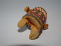 Japanese carved ivory netsuke of a sumo wrestler wearing an elaborate ceremonial kesho-mawashi, signed