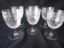 Set of six Edwardian Pall Mall Lady Hamilton cut crystal wine glasses with floral bands and cross-hatched cut decoration.