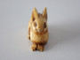 19th-century Japanese ivory rabbit netsuke with folded ears, rich honey patina and historical handling wear.
