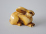 19th-century Japanese ivory rabbit netsuke with folded ears, rich honey patina and historical handling wear.